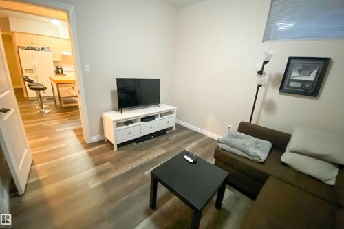 Living area with wood finished floors and baseboards - 10623 75 Avenue, Edmonton, AB - Indoor Photo Showing Living Room