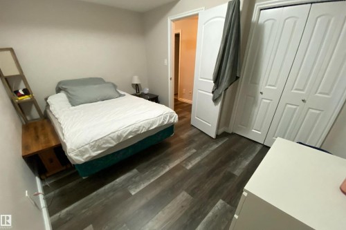 Bedroom featuring dark wood-type flooring and a closet - 10623 75 Avenue, Edmonton, AB - Indoor Photo Showing Bedroom
