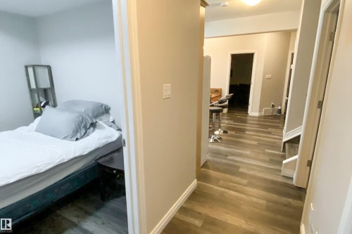 Bedroom featuring dark wood-type flooring and baseboards - 10623 75 Avenue, Edmonton, AB - Indoor