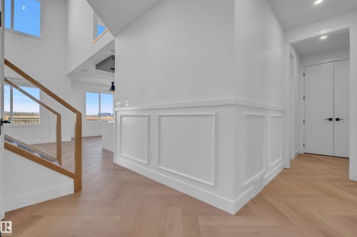 Corridor with parquet floors, recessed lighting, a high ceiling, a wainscoted wall, and a decorative wall - 108 Eldridge Point(E), St. Albert, AB - Indoor Photo Showing Other Room