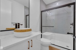 Bathroom with vanity and a marble finish shower - 
