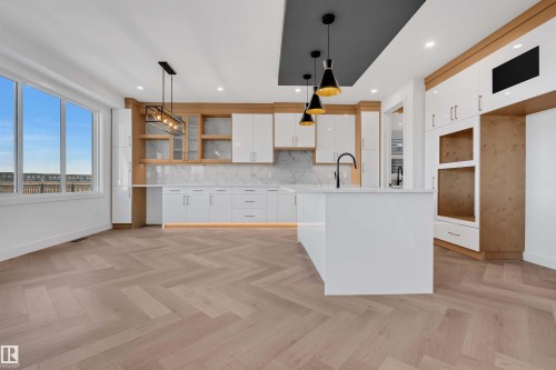 Kitchen with white cabinetry, open shelves, pendant lighting, and parquet floors - 108 Eldridge Point(E), St. Albert, AB - Indoor Photo Showing Kitchen