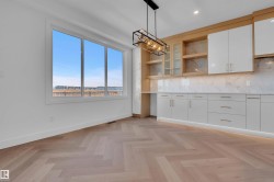 Kitchen with open shelves, white cabinets, tasteful backsplash, decorative light fixtures, and light stone countertops - 