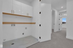 Laundry area with cabinet space, light carpet, recessed lighting, and hookup for a washing machine - 