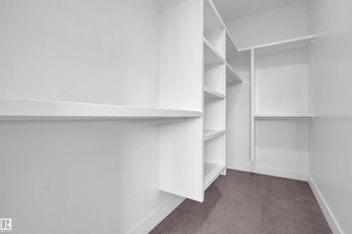 Walk in closet featuring dark carpet - 108 Eldridge Point(E), St. Albert, AB - Indoor With Storage