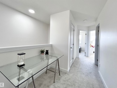 Hallway featuring light carpet and baseboards - 19704 29 Avenue, Edmonton, AB - Indoor Photo Showing Other Room