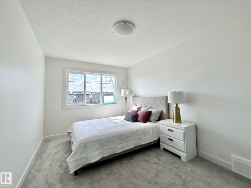 Bedroom with a textured ceiling and light colored carpet - 19704 29 Avenue, Edmonton, AB - Indoor Photo Showing Bedroom