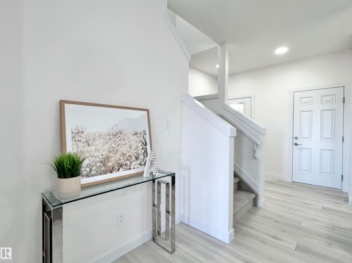 Staircase featuring wood finished floors and recessed lighting - 19704 29 Avenue, Edmonton, AB - Indoor Photo Showing Other Room