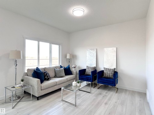 Living area with baseboards and light wood-type flooring - 19704 29 Avenue, Edmonton, AB - Indoor Photo Showing Living Room