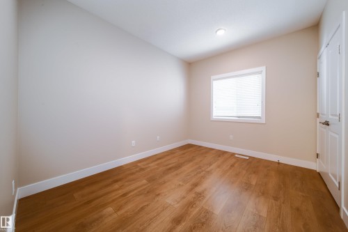 Unfurnished bedroom with light wood-type flooring and a closet - 2237 56 Street, Edmonton, AB - Indoor Photo Showing Other Room