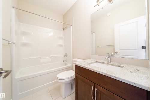 Main floor Bathroom featuring vanity,  shower combination, and light tile patterned floors - 2237 56 Street, Edmonton, AB - Indoor Photo Showing Bathroom
