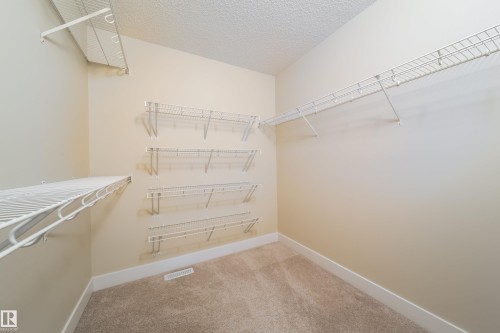 Walk in closet featuring light carpet - 2237 56 Street, Edmonton, AB - Indoor With Storage