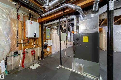 Utilities with water heater, heating unit, and electric panel - 2237 56 Street, Edmonton, AB - Indoor Photo Showing Basement