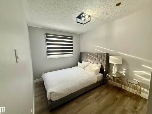 Bedroom with wood finished floors and a textured ceiling - 2915 145 Avenue, Edmonton, AB - Indoor Photo Showing Bedroom