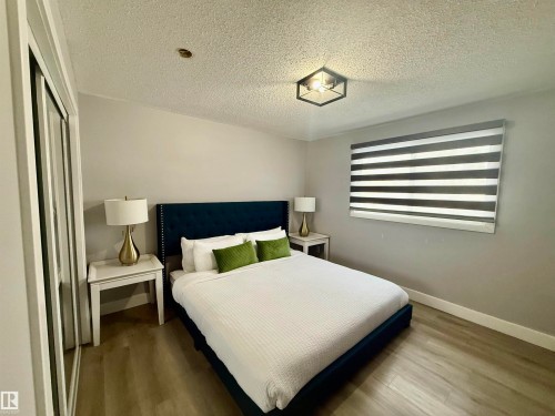Bedroom with wood finished floors, a textured ceiling, and a closet - 2915 145 Avenue, Edmonton, AB - Indoor Photo Showing Bedroom