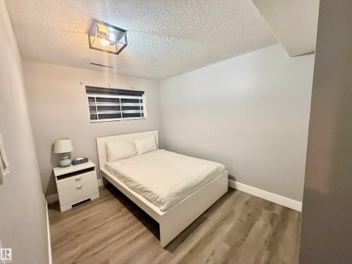 Bedroom with light wood-style flooring and a textured ceiling - 2915 145 Avenue, Edmonton, AB - Indoor Photo Showing Bedroom
