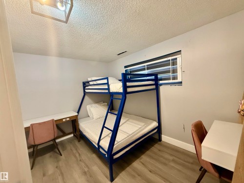 Bedroom with a textured ceiling and light wood-style floors - 2915 145 Avenue, Edmonton, AB - Indoor Photo Showing Bedroom