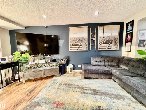 Living room with light wood finished floors and a textured ceiling - 425 Sheppard Boulevard, Leduc, AB - Indoor Photo Showing Living Room