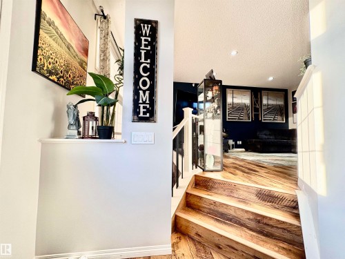 Stairway featuring recessed lighting and wood finished floors - 425 Sheppard Boulevard, Leduc, AB - Indoor Photo Showing Other Room
