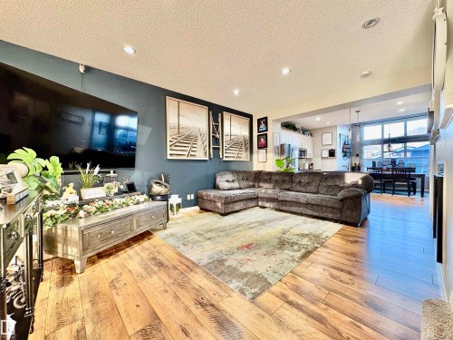 Living area with a textured ceiling, light wood-type flooring, and recessed lighting - 425 Sheppard Boulevard, Leduc, AB - Indoor Photo Showing Living Room