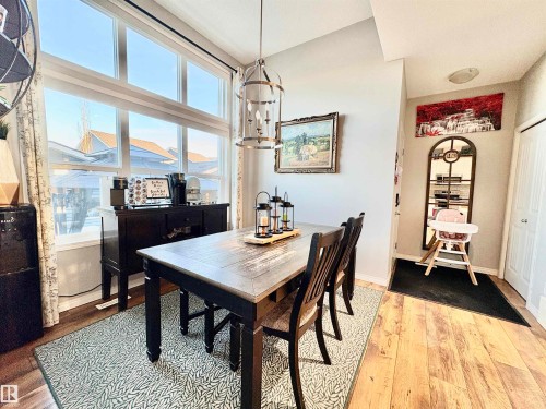 Dining area with wood finished floors and baseboards - 425 Sheppard Boulevard, Leduc, AB - Indoor Photo Showing Dining Room