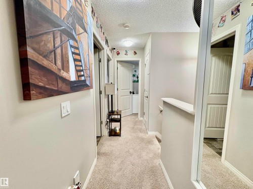 Hallway with light colored carpet and a textured ceiling - 425 Sheppard Boulevard, Leduc, AB - Indoor Photo Showing Other Room
