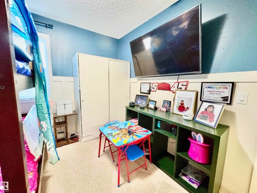 Rec room featuring a textured ceiling and light carpet - 425 Sheppard Boulevard, Leduc, AB - Indoor