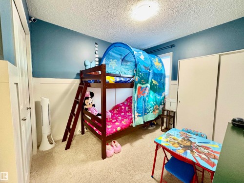 Bedroom with light colored carpet and a textured ceiling - 425 Sheppard Boulevard, Leduc, AB - Indoor