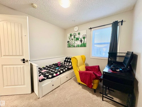 Bedroom featuring light carpet and a textured ceiling - 425 Sheppard Boulevard, Leduc, AB - Indoor Photo Showing Bedroom
