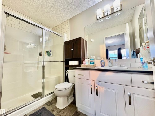 Bathroom featuring vanity, a shower stall, and a textured ceiling - 425 Sheppard Boulevard, Leduc, AB - Indoor Photo Showing Bathroom