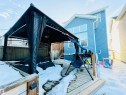 Snow covered rear of property with a gazebo, a fenced backyard, and a wooden deck - 425 Sheppard Boulevard, Leduc, AB  - Outdoor 