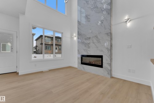 3606 40 Avenue, Beaumont, AB - Indoor Photo Showing Living Room With Fireplace