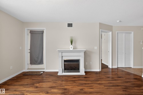 102 1589 Glastonbury Boulevard, Edmonton, AB - Indoor Photo Showing Other Room With Fireplace