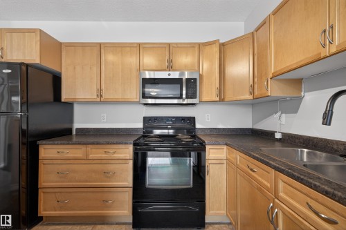 102 1589 Glastonbury Boulevard, Edmonton, AB - Indoor Photo Showing Kitchen With Double Sink
