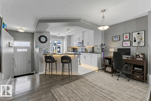 Office featuring a textured ceiling and light wood-style flooring - #127 2905 141 Street, Edmonton, AB - Indoor