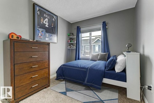 Bedroom featuring a textured ceiling and light carpet - #127 2905 141 Street, Edmonton, AB - Indoor Photo Showing Bedroom