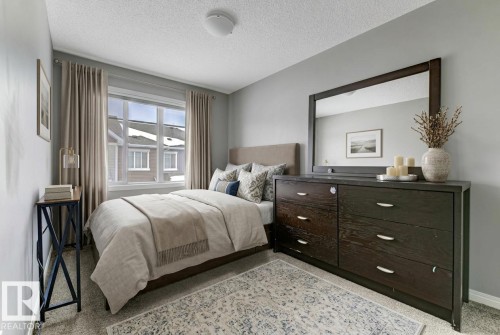Bedroom with baseboards and a textured ceiling - #127 2905 141 Street, Edmonton, AB - Indoor Photo Showing Bedroom