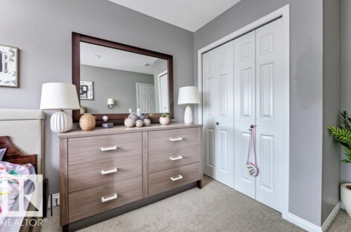 Bedroom with light carpet, a closet, and a textured ceiling - #127 2905 141 Street, Edmonton, AB - Indoor Photo Showing Bedroom