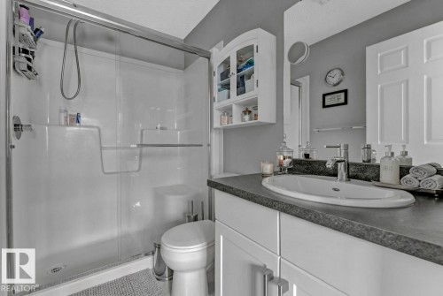 Full bath with vanity, a stall shower, and tile patterned flooring - #127 2905 141 Street, Edmonton, AB - Indoor Photo Showing Bathroom