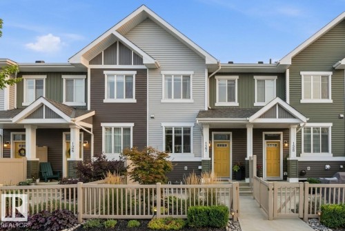 Craftsman inspired home with a fenced front yard, covered porch, and a gate - #127 2905 141 Street, Edmonton, AB - Outdoor With Facade