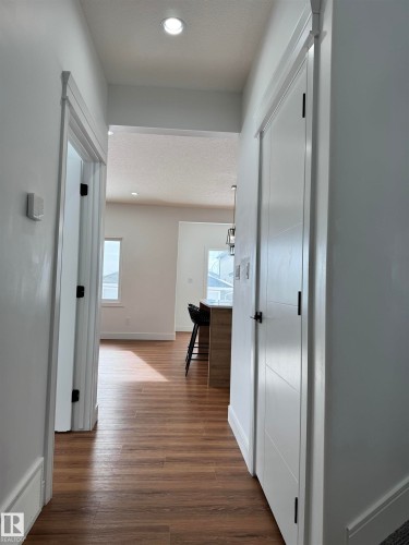 Corridor with recessed lighting, dark wood finished floors, and a textured ceiling - 1703 152 Avenue, Edmonton, AB - Indoor Photo Showing Other Room