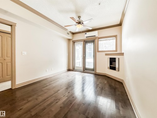 121 10121 80 Avenue, Edmonton, AB - Indoor Photo Showing Other Room With Fireplace