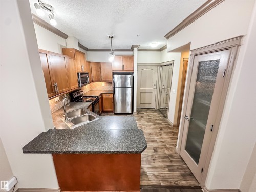 121 10121 80 Avenue, Edmonton, AB - Indoor Photo Showing Kitchen With Stainless Steel Kitchen With Double Sink