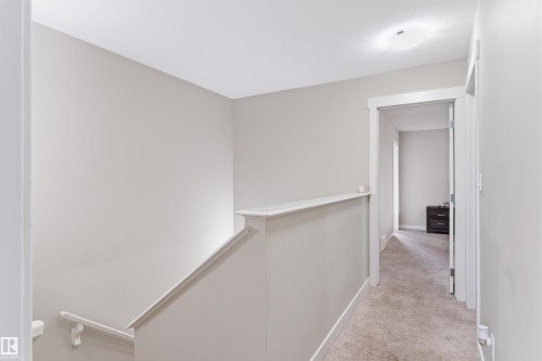 Corridor with an upstairs landing and light carpet - 149 Hawks Ridge Boulevard, Edmonton, AB - Indoor Photo Showing Other Room