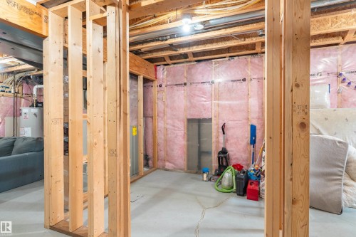 Unfinished below grade area with water heater - 149 Hawks Ridge Boulevard, Edmonton, AB - Indoor Photo Showing Basement