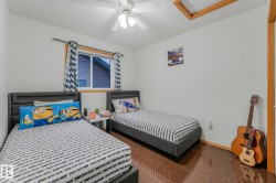 Bedroom with attic access and a ceiling fan - 