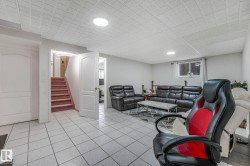 Family room featuring stairs and light tile patterned floors - 
