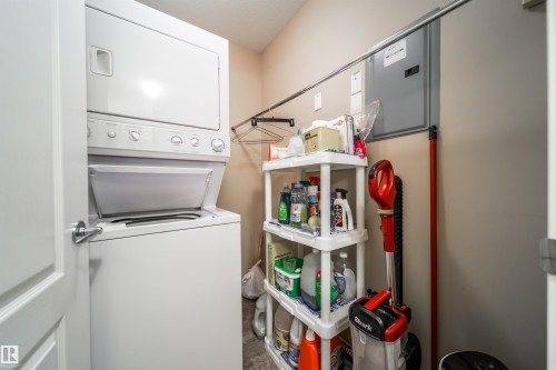 Laundry area with stacked washer and clothes dryer - 237 278 Suder Greens Drive, Edmonton, AB - Indoor Photo Showing Laundry Room