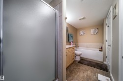 Bathroom featuring vanity, a bath, and a shower stall - 