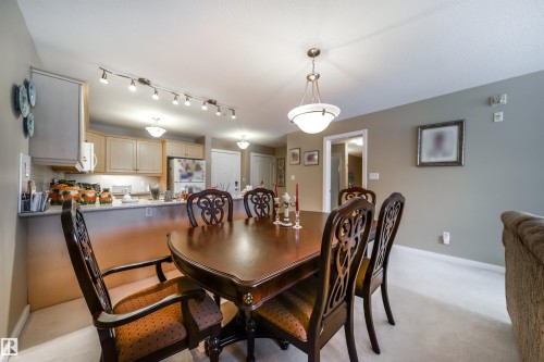 Dining space featuring baseboards and light carpet - 237 278 Suder Greens Drive, Edmonton, AB - Indoor Photo Showing Dining Room